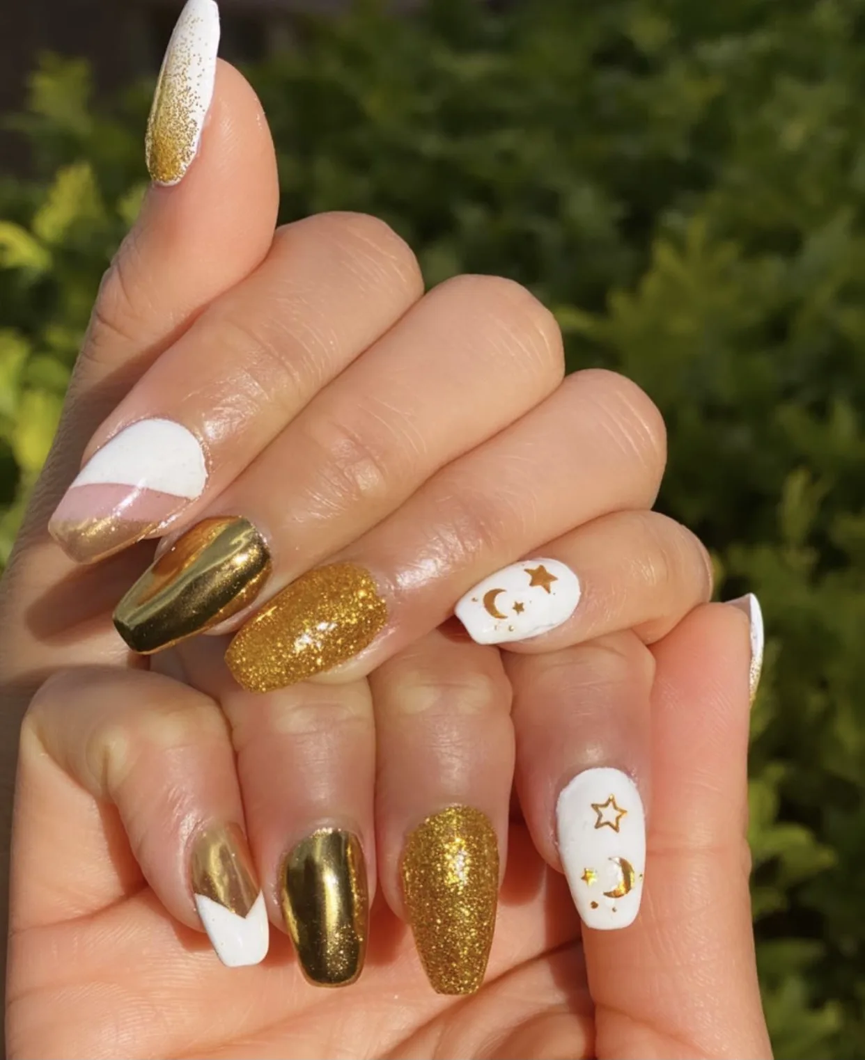 Finished nails — white, chrome-gold, gold glitter and moon-star art
