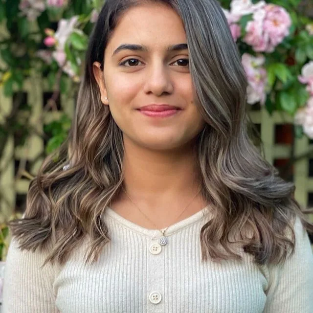 Ash-brown balayage waves, smiling, rose trellis behind