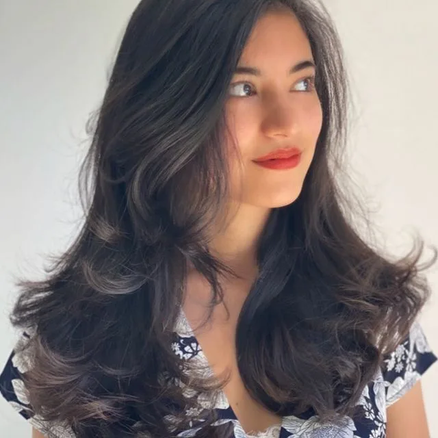 Glossy dark-brown blow-dry waves, red lip