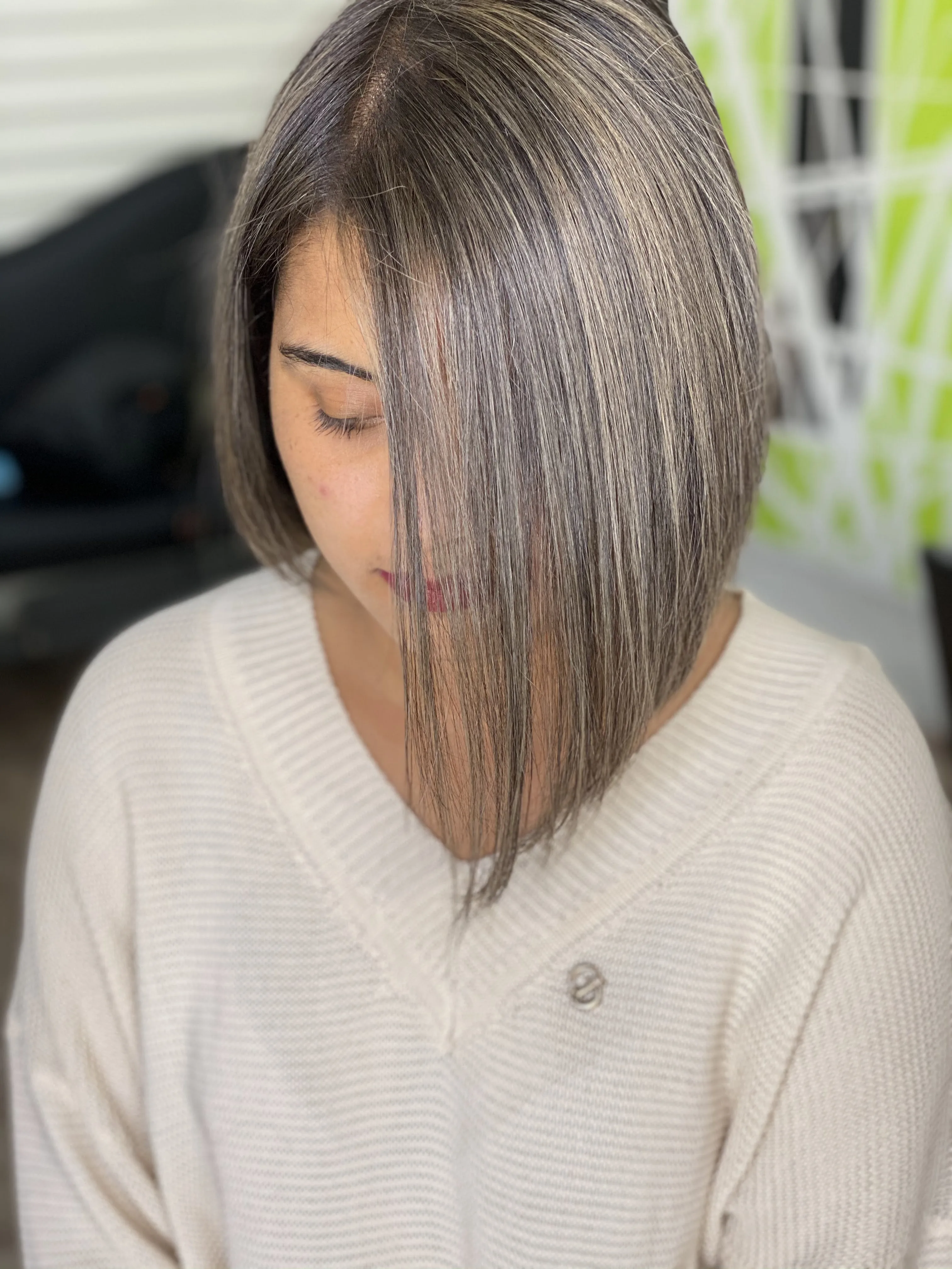 Ash-silver blunt bob, top-down view, cream jumper