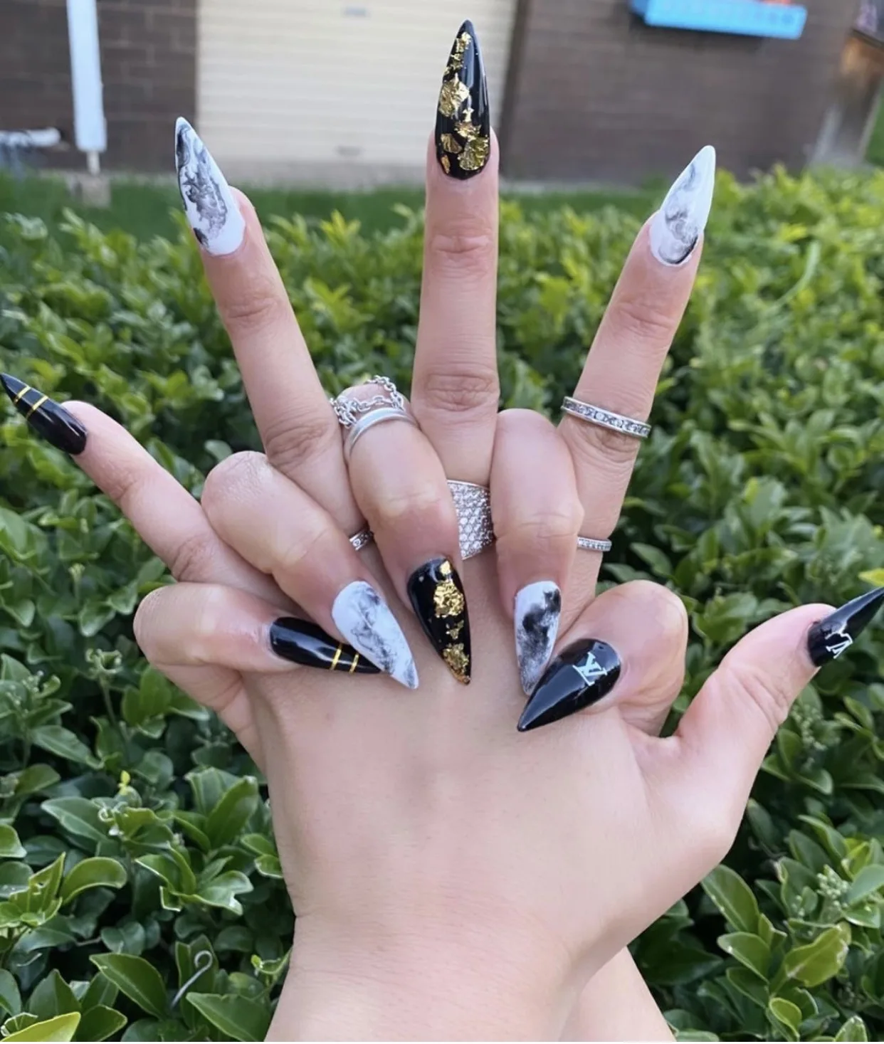 Long black, white and gold marble stiletto nails with gold-foil accents
